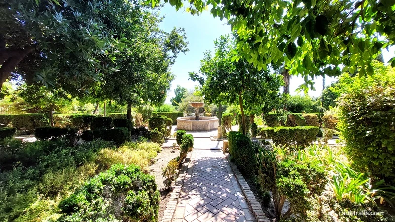 Garden with a stone fountain at the Alcázar of Córdoba, Spain, taken at midday in September 2024 used as an example of alt text for travel photos.