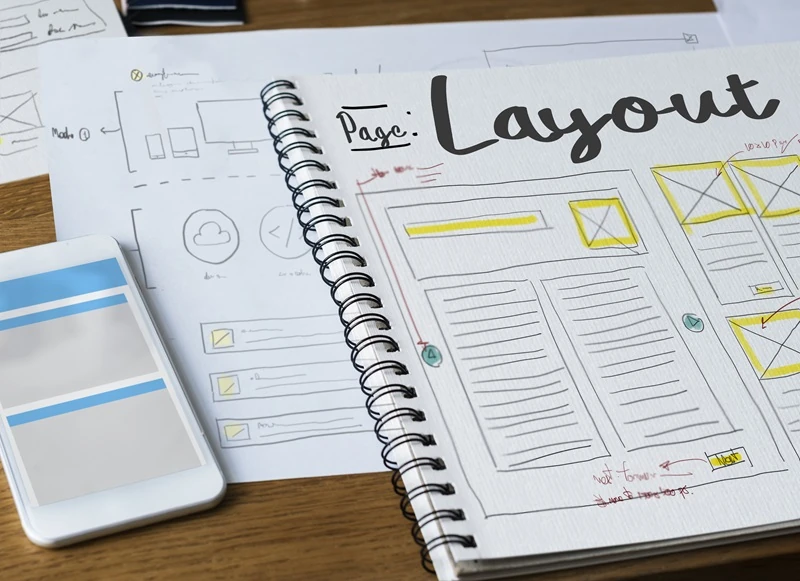 Notebook with web page layout sketches symbolizing how to structure content for SEO and AI visibility.